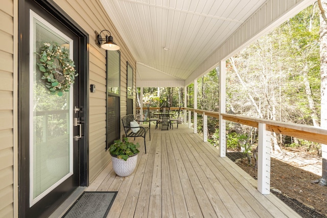 wooden terrace featuring covered porch