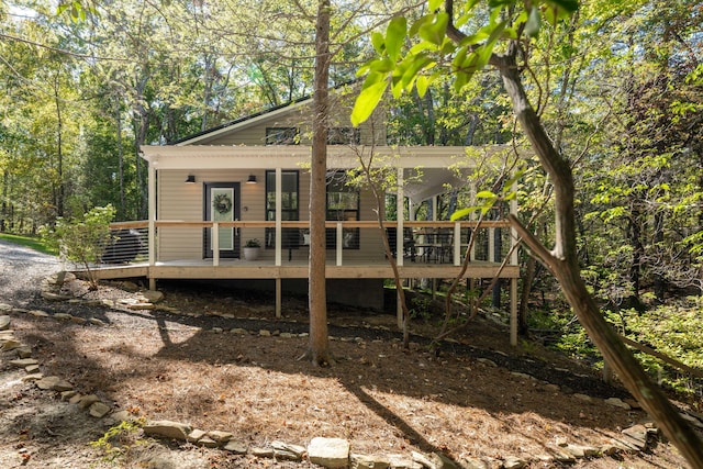 back of house featuring a wooden deck