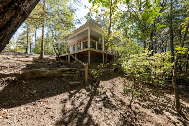 rear view of house featuring a wooden deck