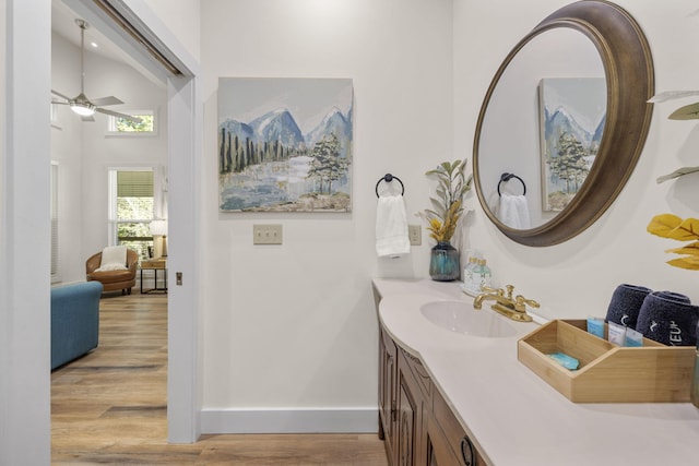 bathroom featuring a ceiling fan, wood finished floors, vanity, and baseboards