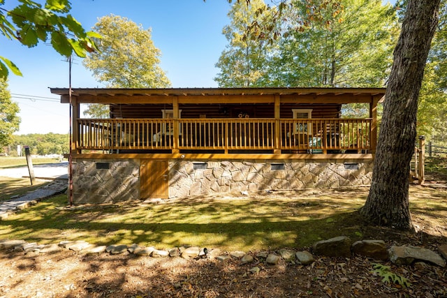 back of property with crawl space and a deck