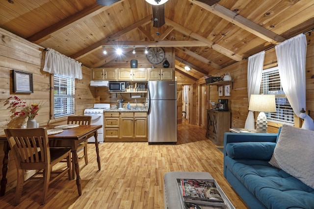 kitchen with white range, light countertops, freestanding refrigerator, and wooden walls