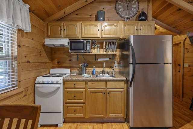 kitchen with sink, wood walls, light hardwood / wood-style floors, lofted ceiling, and appliances with stainless steel finishes