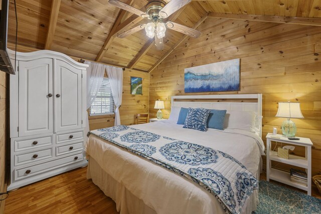 bedroom with ceiling fan, vaulted ceiling with beams, wooden walls, wood ceiling, and dark wood-style floors