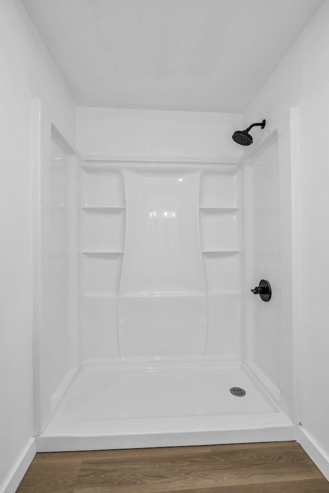 bathroom featuring hardwood / wood-style flooring and a shower