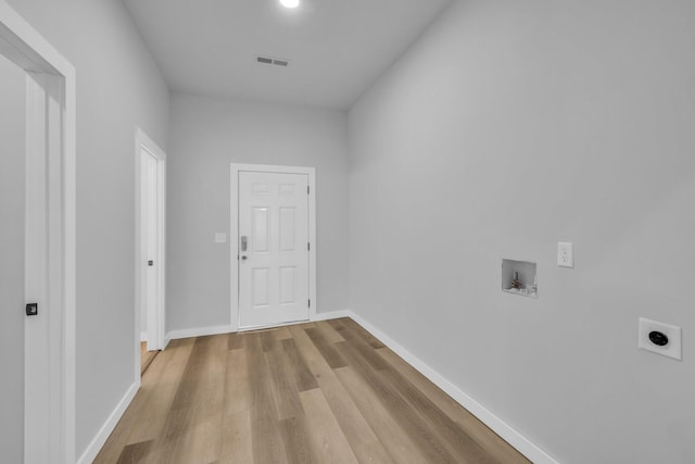 interior space featuring electric dryer hookup, light hardwood / wood-style floors, and hookup for a washing machine