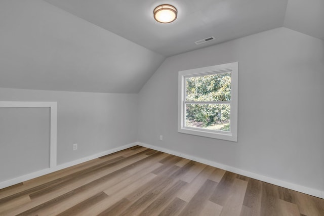 bonus room featuring wood-type flooring and vaulted ceiling