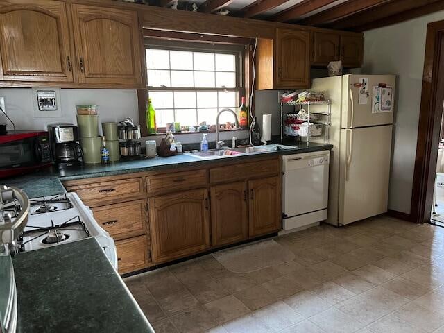 kitchen featuring white appliances and sink