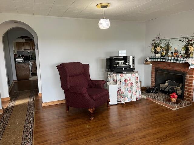 sitting room featuring a fireplace and dark hardwood / wood-style floors