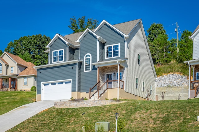 view of front of property featuring a front yard and a garage