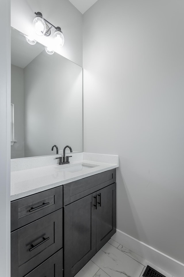 bathroom with baseboards, visible vents, vanity, and marble finish floor