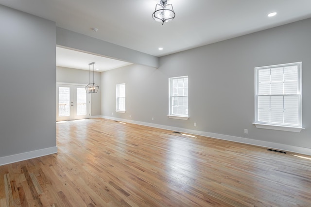 unfurnished room with recessed lighting, baseboards, visible vents, and light wood-type flooring