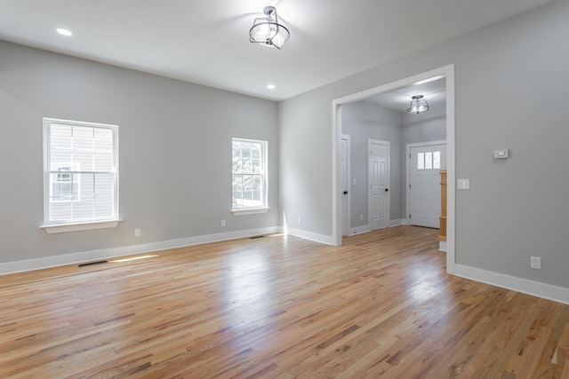 empty room with recessed lighting, baseboards, visible vents, and light wood-style flooring