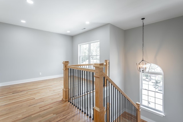stairs featuring baseboards, recessed lighting, wood finished floors, and a chandelier