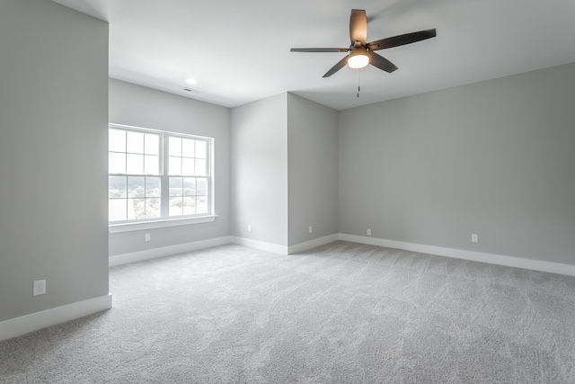 spare room with light carpet and ceiling fan