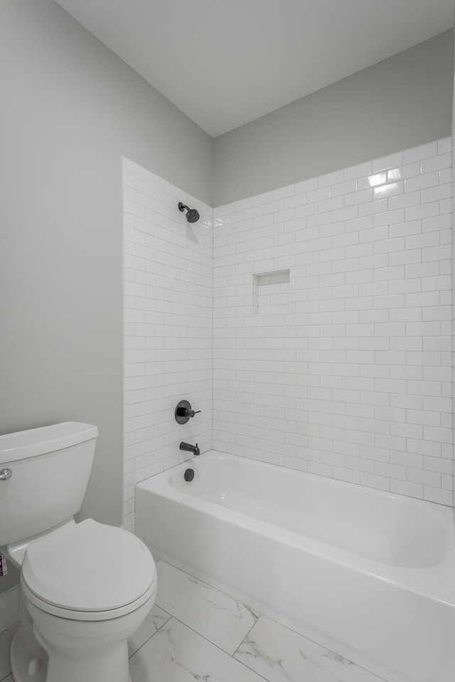 full bath featuring toilet, shower / tub combination, and marble finish floor