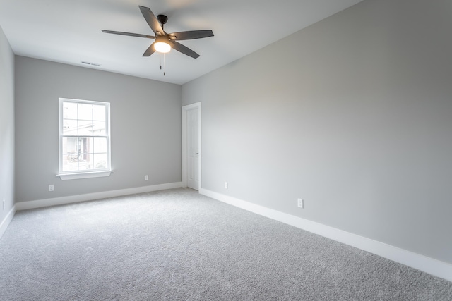 carpeted empty room featuring ceiling fan