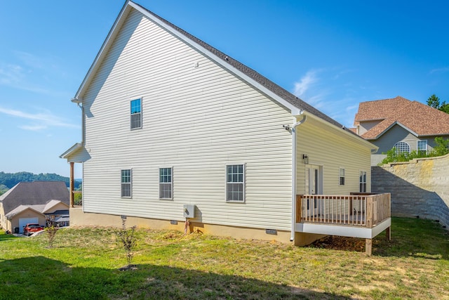 back of property featuring a lawn and crawl space