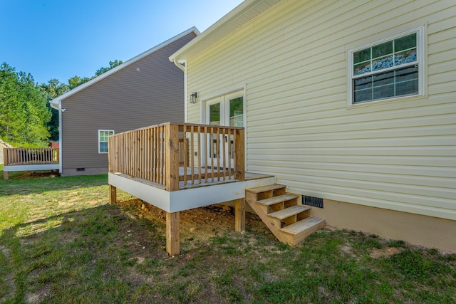 rear view of property with a yard, crawl space, and a wooden deck
