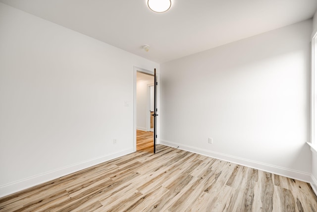 unfurnished room with light hardwood / wood-style floors