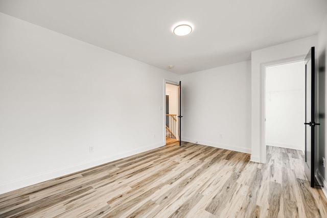 unfurnished room with light wood-type flooring