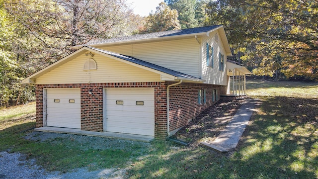 view of side of property with a yard and a garage