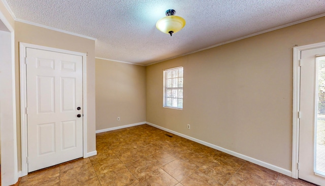 spare room featuring ornamental molding and a textured ceiling