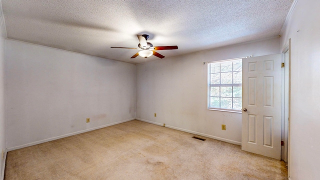 unfurnished room featuring light carpet, a textured ceiling, and ceiling fan