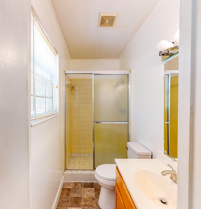 bathroom featuring vanity, a shower with shower door, toilet, and tile patterned floors