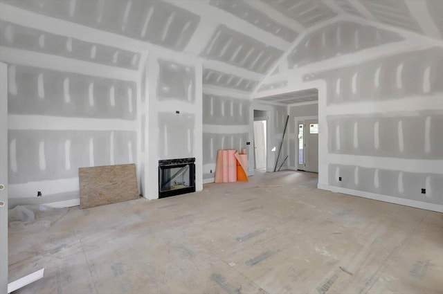 unfurnished living room with lofted ceiling and a fireplace