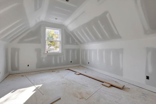 additional living space featuring vaulted ceiling