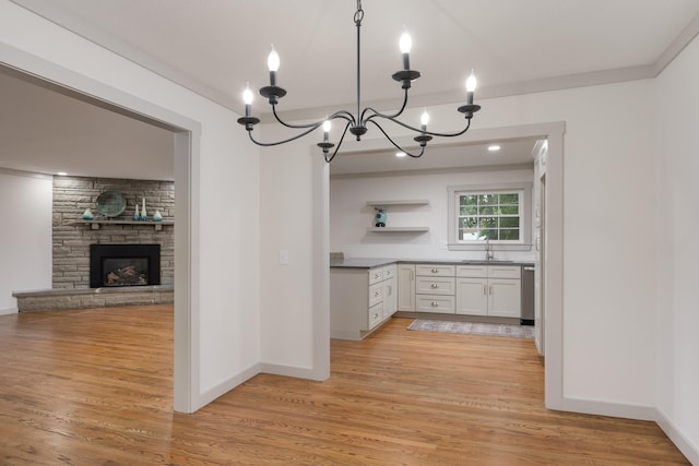 4011 Patton Edwards Dr, Chattanooga, TN 37412 - kitchen with open shelves, light wood-style floors, a chandelier, and white cabinets