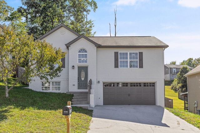 view of front of home with a front yard and a garage