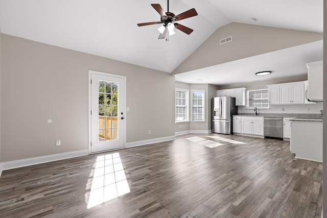 unfurnished living room with dark hardwood / wood-style floors, high vaulted ceiling, sink, and ceiling fan