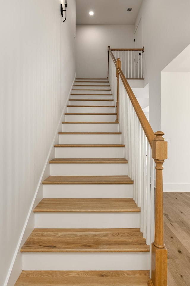 stairway featuring hardwood / wood-style floors