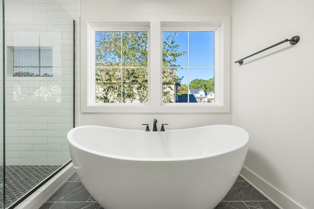 bathroom with tile patterned flooring, plenty of natural light, and plus walk in shower