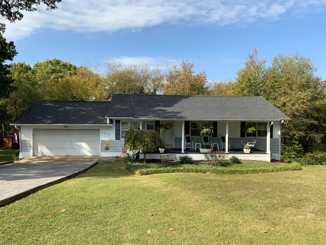 single story home with covered porch, a front yard, and a garage