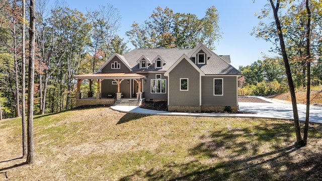 view of front of home with a front yard and a porch