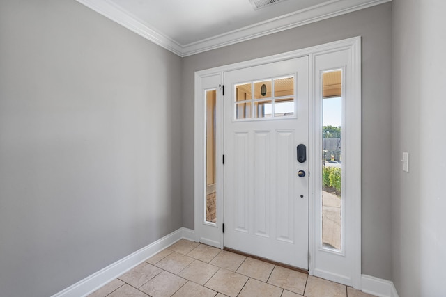 tiled foyer entrance featuring crown molding