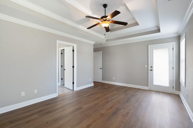 unfurnished room featuring ornamental molding, hardwood / wood-style floors, ceiling fan, and a tray ceiling