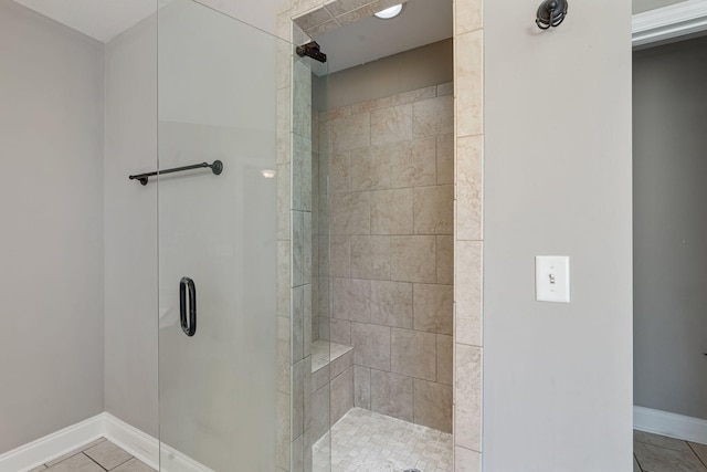 bathroom with tile patterned floors and a shower with door