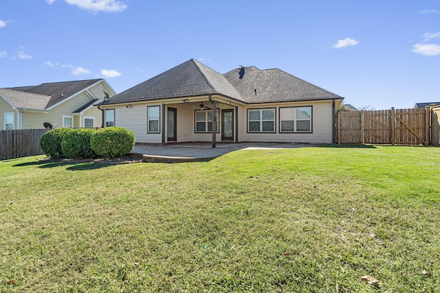 rear view of house with a lawn, ceiling fan, and a patio area