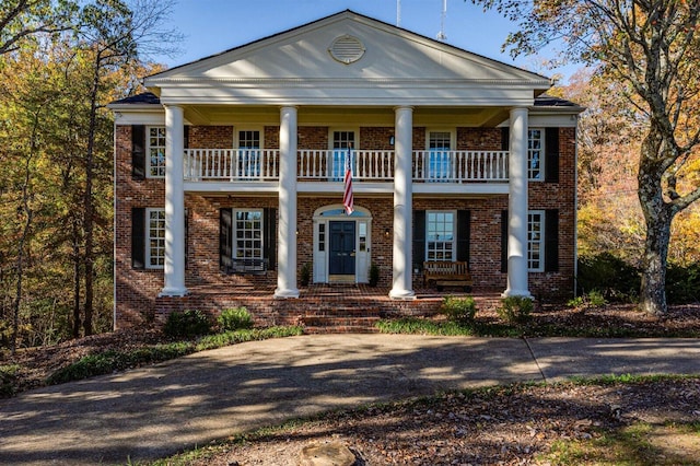 greek revival house with a balcony