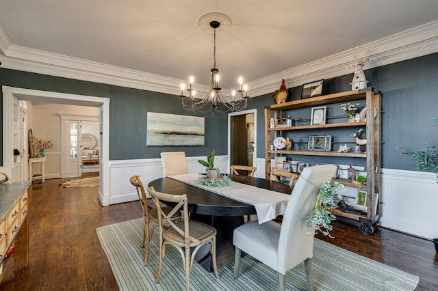 dining area featuring ornamental molding, dark wood-type flooring, and an inviting chandelier