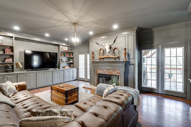 living room featuring french doors, ornamental molding, and light hardwood / wood-style floors