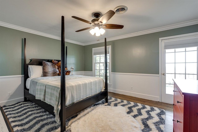 bedroom with ceiling fan, ornamental molding, and dark hardwood / wood-style floors