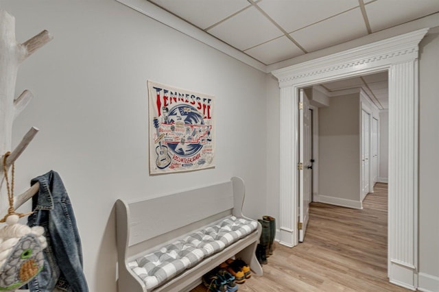 hallway with light hardwood / wood-style floors and a drop ceiling