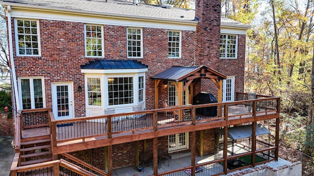 back of house with a wooden deck and french doors