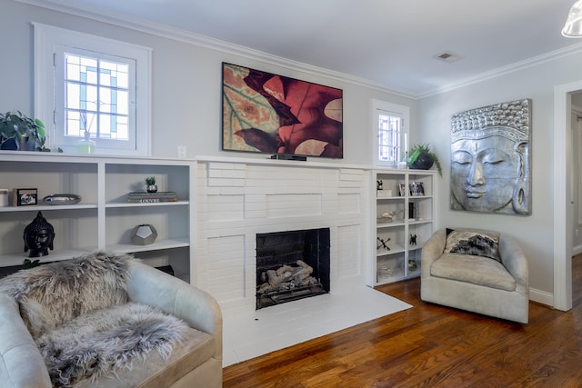 living room with a healthy amount of sunlight, a fireplace, ornamental molding, and dark hardwood / wood-style floors