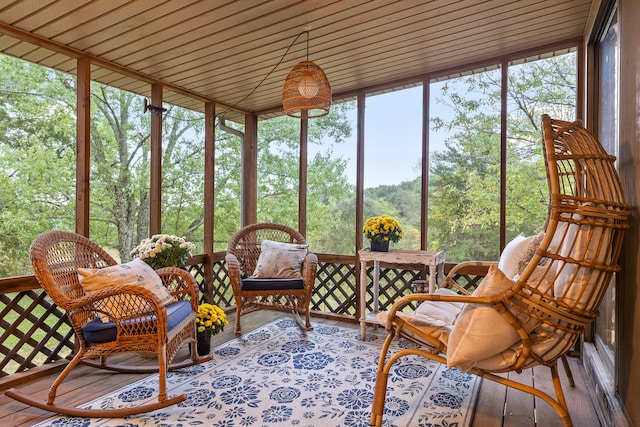 sunroom / solarium featuring wood ceiling and a healthy amount of sunlight